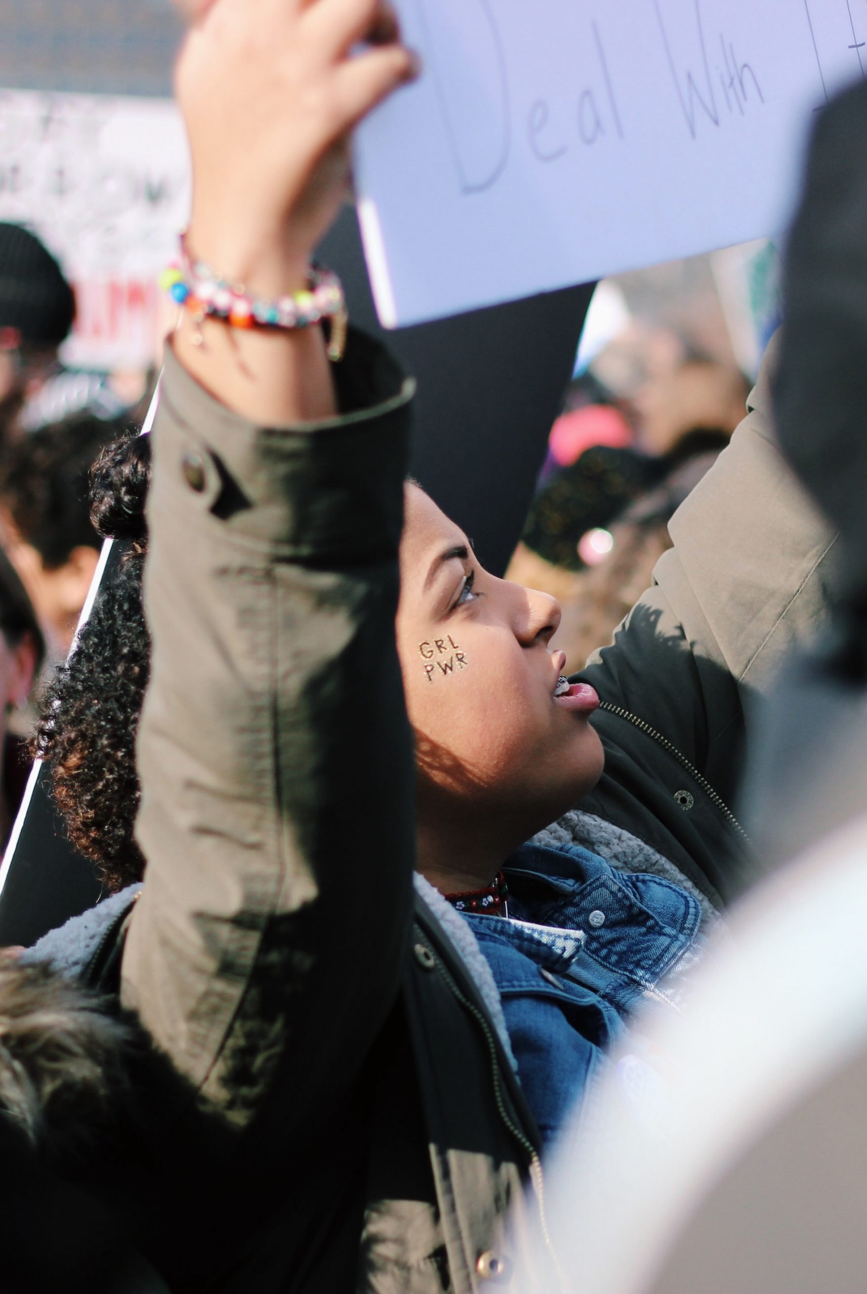 Women holding up a protest poster.