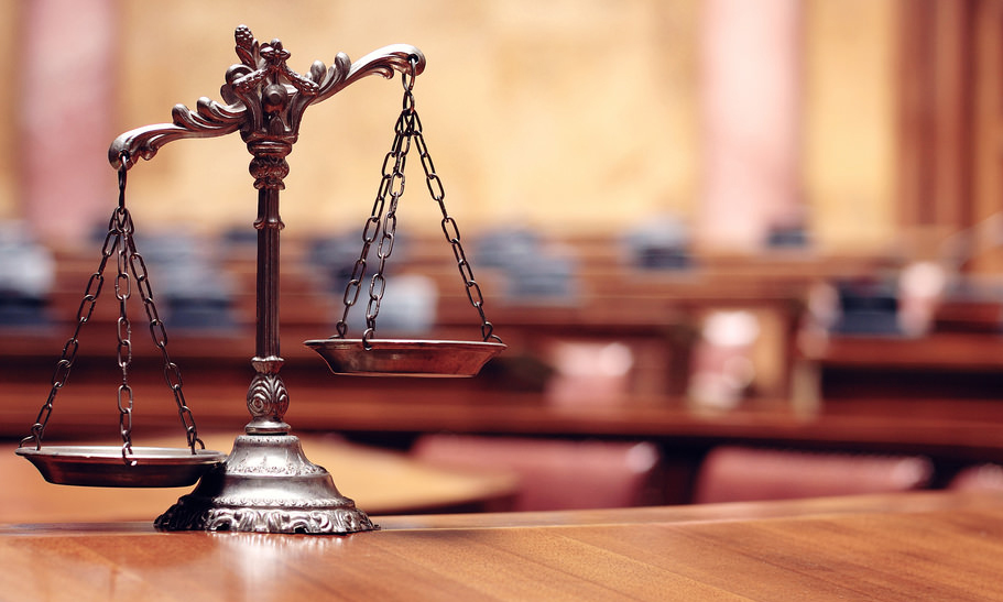 image of a Lady Justice scale on a plenarium table as representation of law